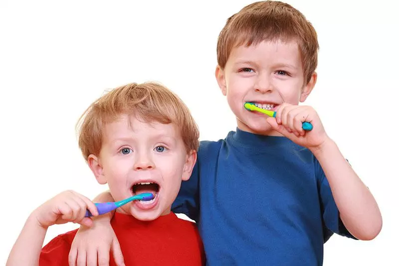 two boys brushing their teeth